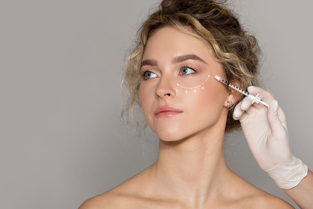medico-estetista-che-fa-l-iniezione-alla-donna-con-la-linea-disegnata-sotto-la-signora-degli-occhi-che-ottiene-la-mesoterapia.jpg